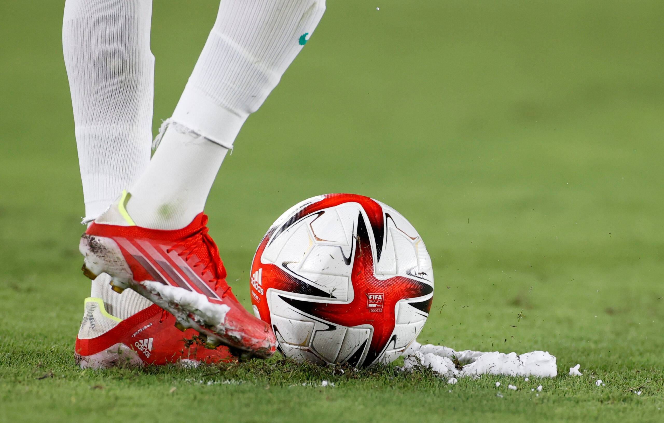 Footballer lines up a free-kick.