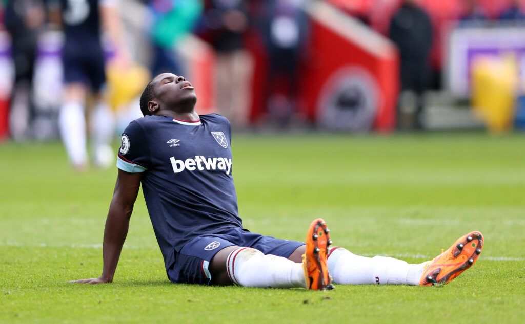 Kurt Zouma of West Ham United reacts as he appears to be injured during the Premier League match between Brentford and West Ham United at Brentford Community Stadium on April 10, 2022