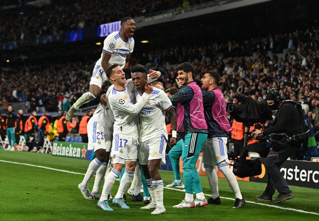 Karim Benzema of Real Madrid CF celebrates with his team mates after scoring his team's second goal during the UEFA Champions League Quarter Final Leg Two match between Real Madrid and Chelsea FC at Estadio Santiago Bernabeu
