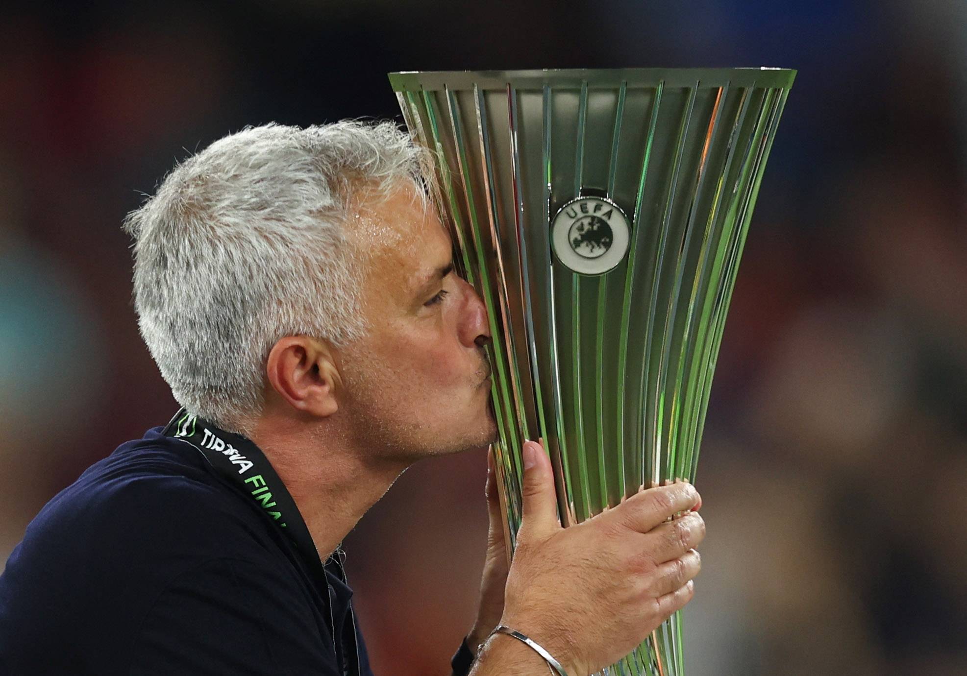 Roma's Mourinho kisses the trophy.