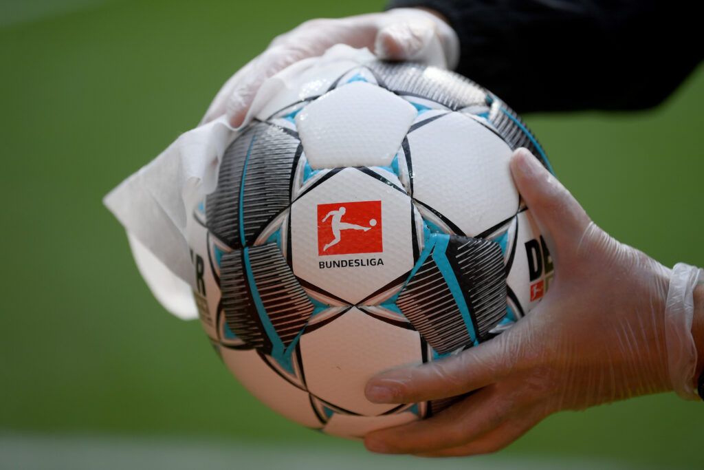 An employee of Werder Bremen disinfects an official match ball ahead of the Bundesliga match between SV Werder Bremen and Bayer 04 Leverkusen at Wohninvest Weserstadion on May 18, 2020 in Bremen, Germany. 