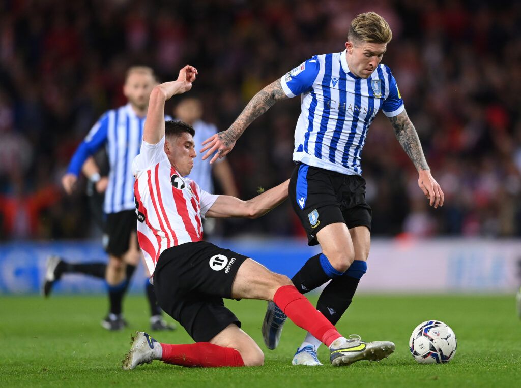 Sunderland player Ross Stewart tackles Josh Windass of Wednesday during the Sky Bet League One Play-Off Semi Final 1st Leg match between Sunderland and Sheffield Wednesday at Stadium of Light on May 06, 2022