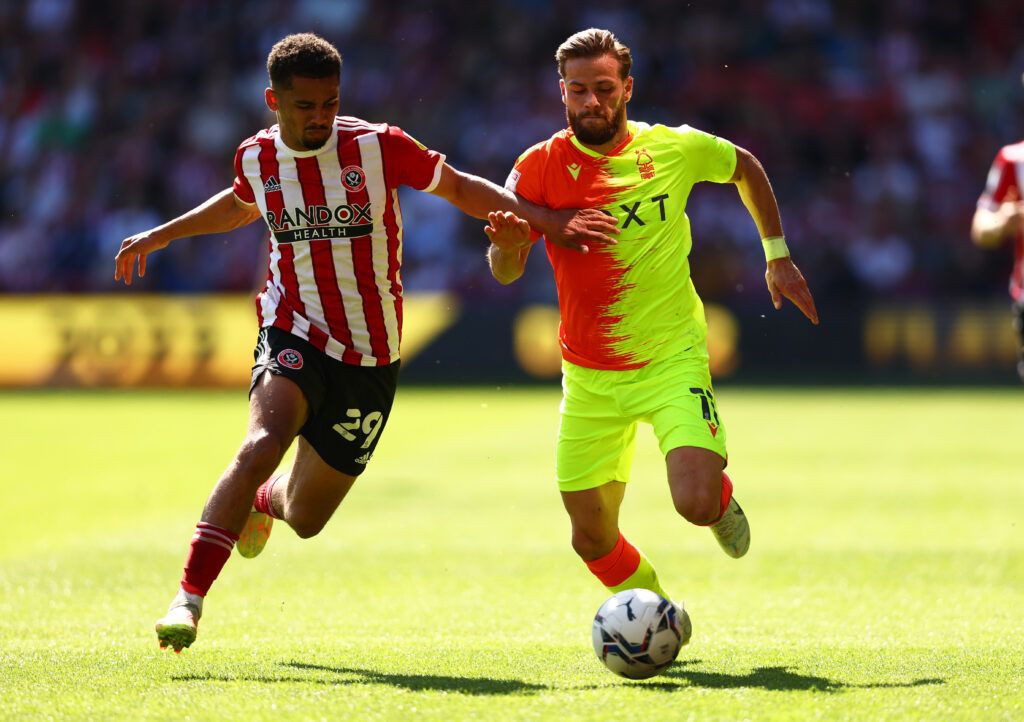 Iliman Ndiaye of Sheffield United battles for possession with Philip Zinckernagel of Nottingham Forest during the Sky Bet Championship Play-Off Semi Final 1st Leg match between Sheffield United and Nottingham Forest at Bramall Lane on May 14, 2022 in Sheffield, England. 