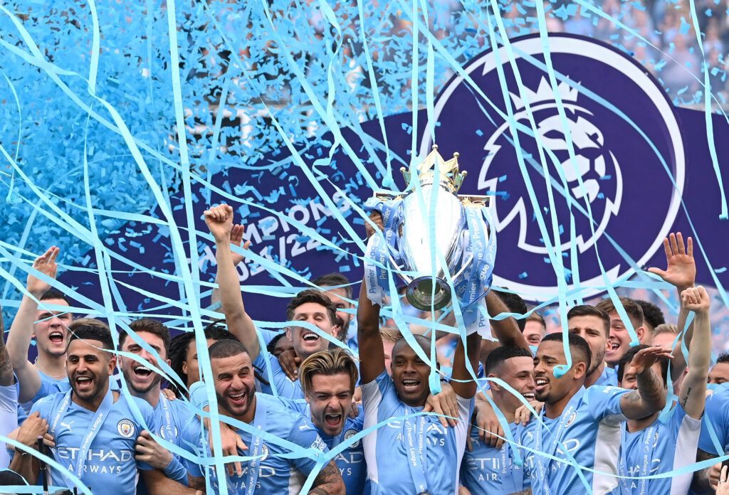 Manchester City captain Fernandinho lifts the Premier League Trophy and celebrates with the squad after the Premier League match between Manchester City and Aston Villa at Etihad Stadium on May 22, 2022 