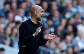Pep Guardiola giving instructions to Manchester City players during a Premier League game
