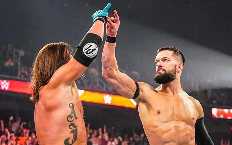 Finn Balor and AJ Styles give the 'Two Sweet' gesture 