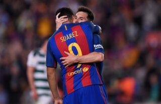 Suarez and Messi hug.