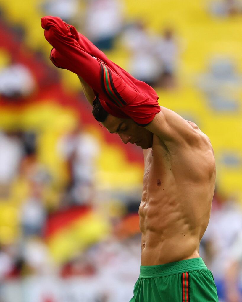 Ronaldo takes off his shirt.