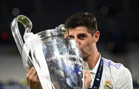 Courtois kisses the Champions League trophy.