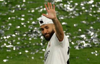 Real Madrid's Benzema waves.