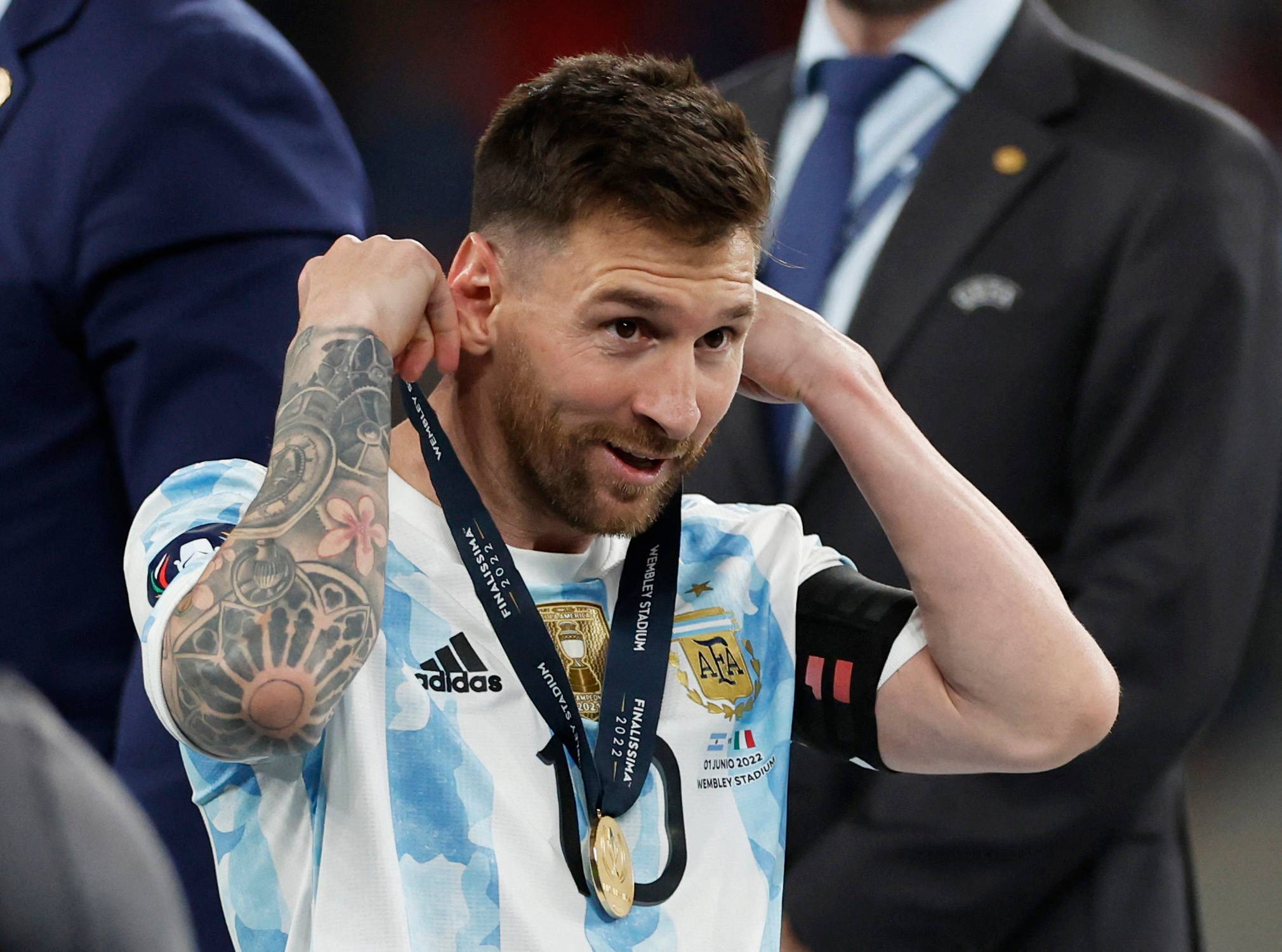 Messi puts on his medal.