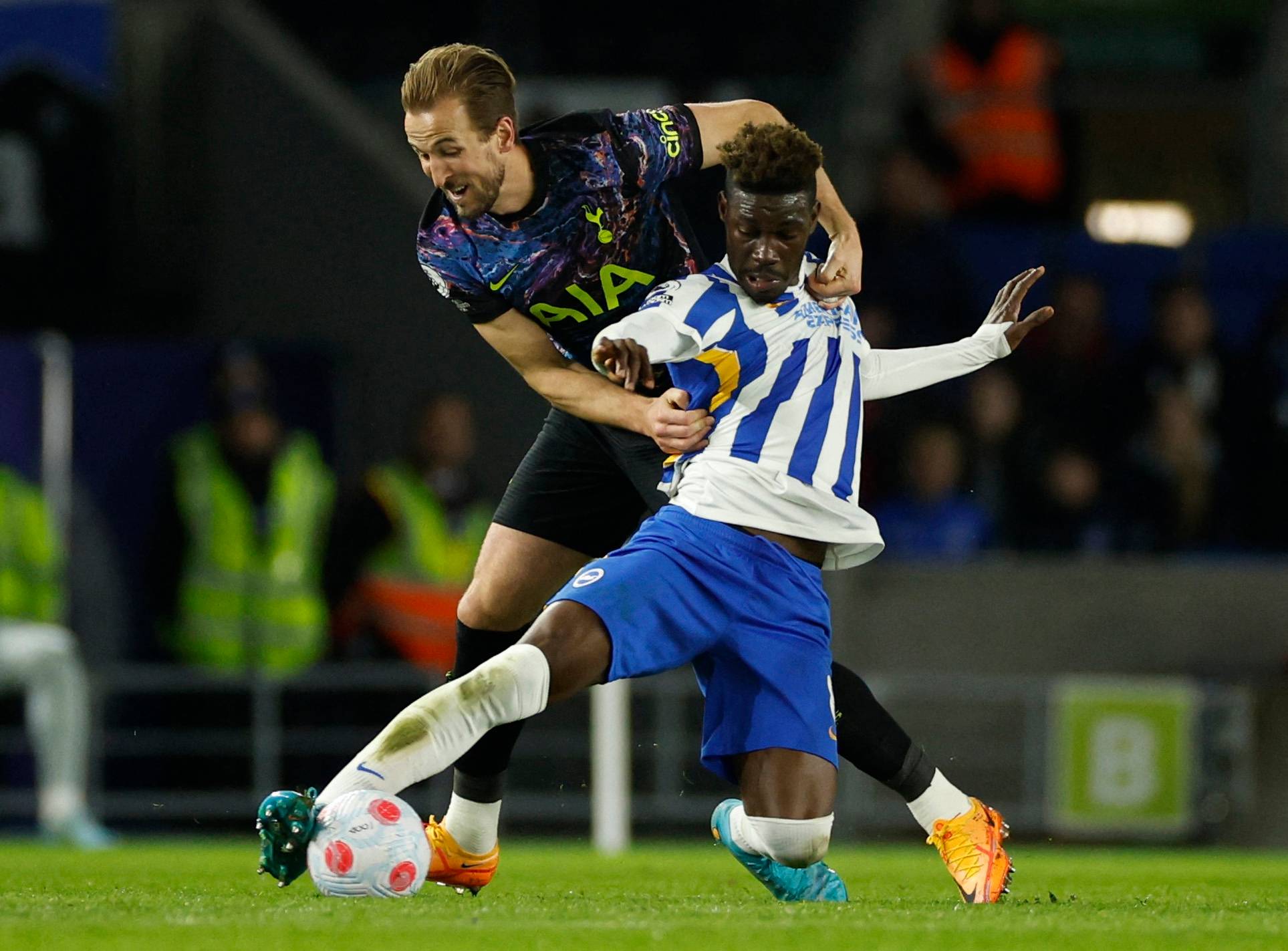 Brighton midfielder Yves Bissouma tackling Tottenham striker Harry Kane