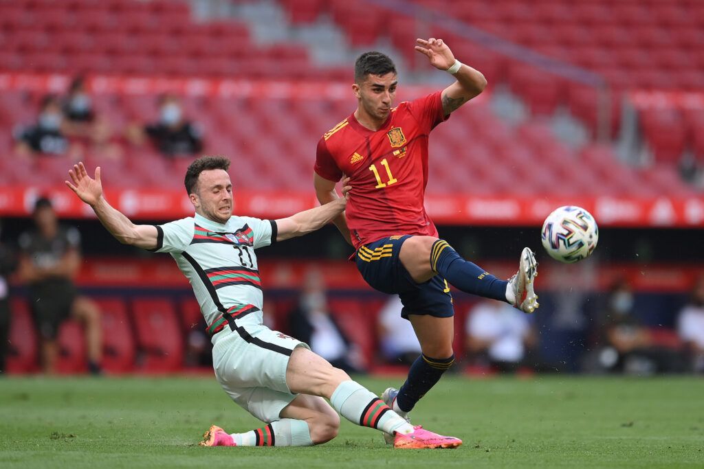 Ferran Torres of Spain is challenged by Diogo Jota 
