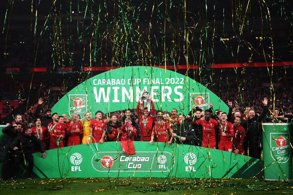 Jordan Henderson of Liverpool lifts the Carabao Cup trophy following victory in the Carabao Cup Final match between Chelsea and Liverpool at Wembley Stadium on February 27, 2022 in London, England