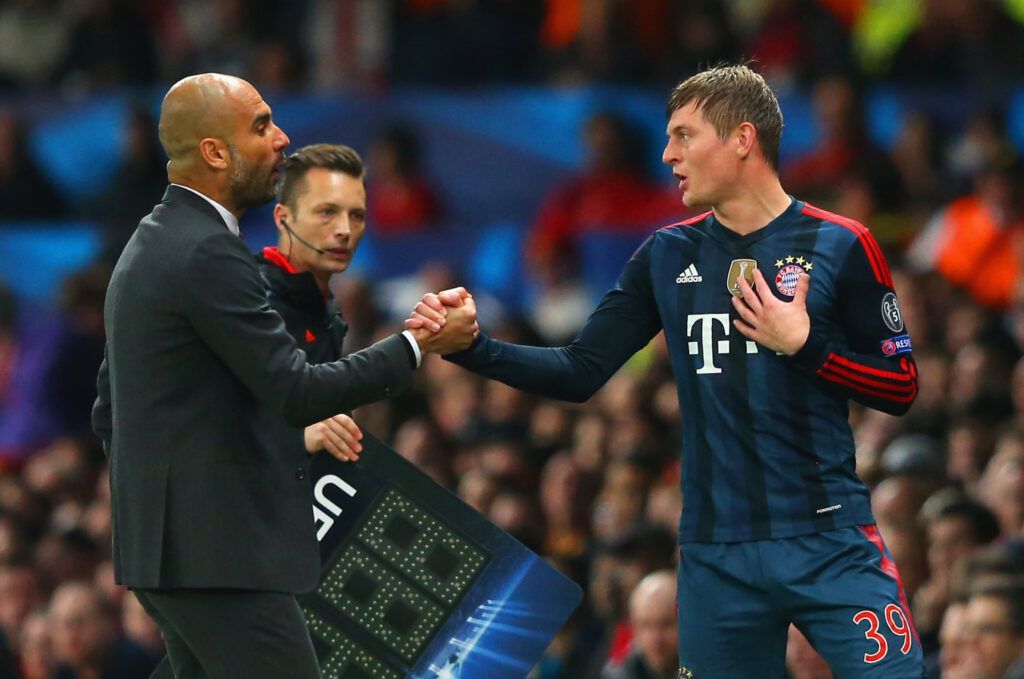 Kroos and Guardiola in conversation on the touchline for Bayern Munich