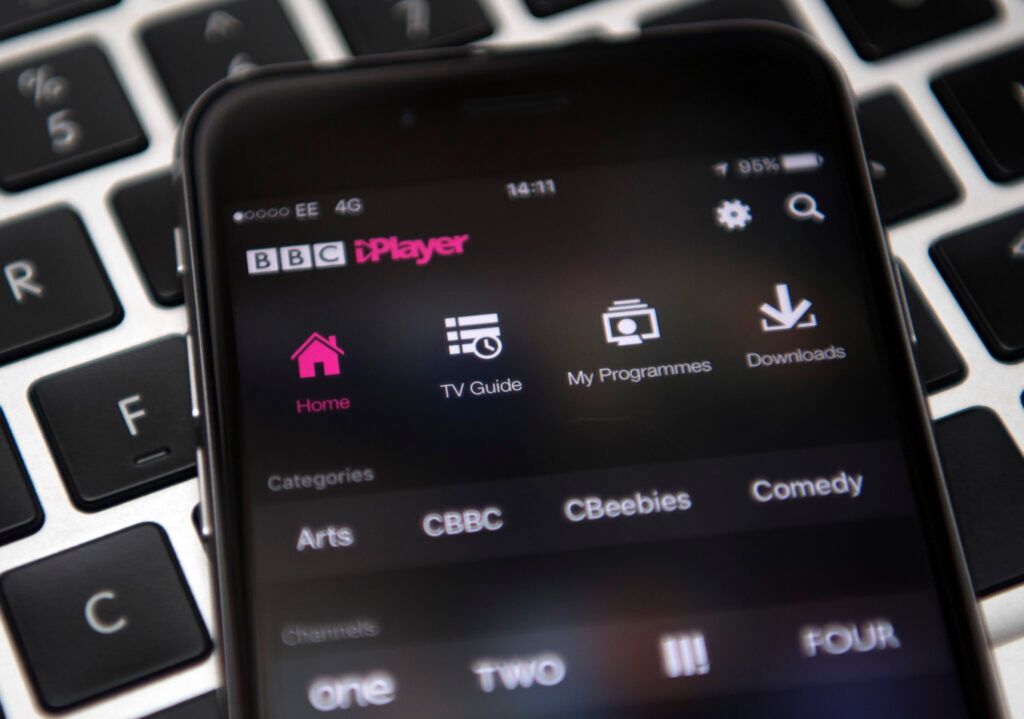 In this photo illustration, the BBC iPlayer app is displayed on an iPhone left over a laptop keyboard on August 2, 2016 in London, England. The BBC has announced that iPlayer users will have to pay a 145GBP TV licence fee from 1 September.  