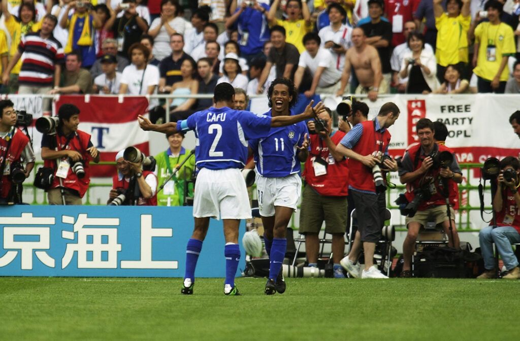 Ronaldinho celebrates his free-kick with Cafu