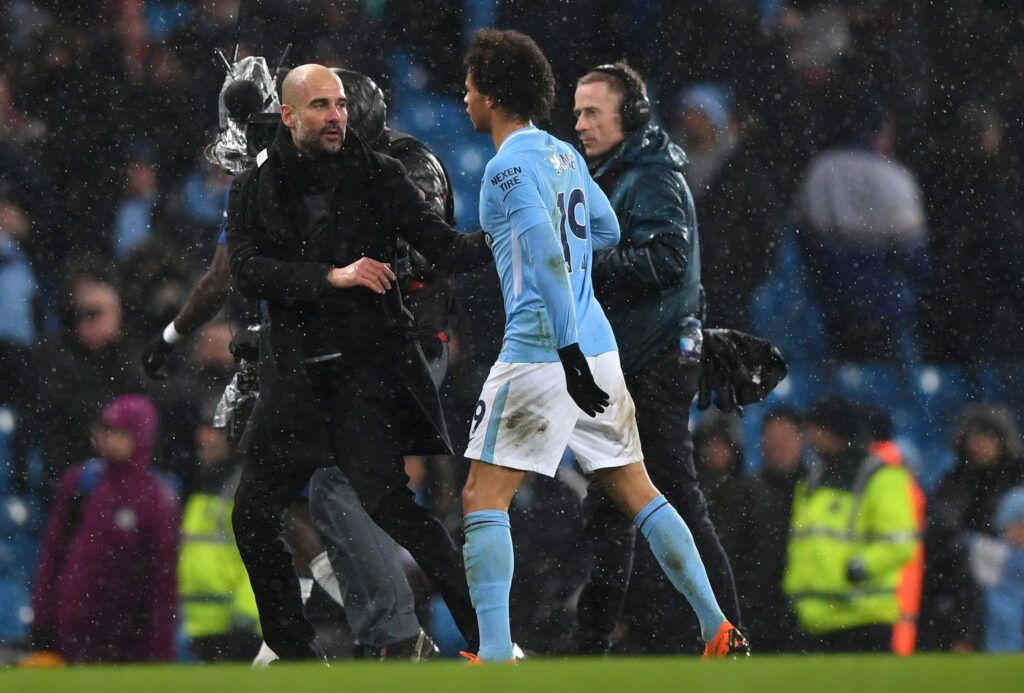 Guardiola talks to Sane as the two leave the pitch