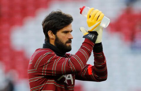 Liverpool's Alisson clapping.