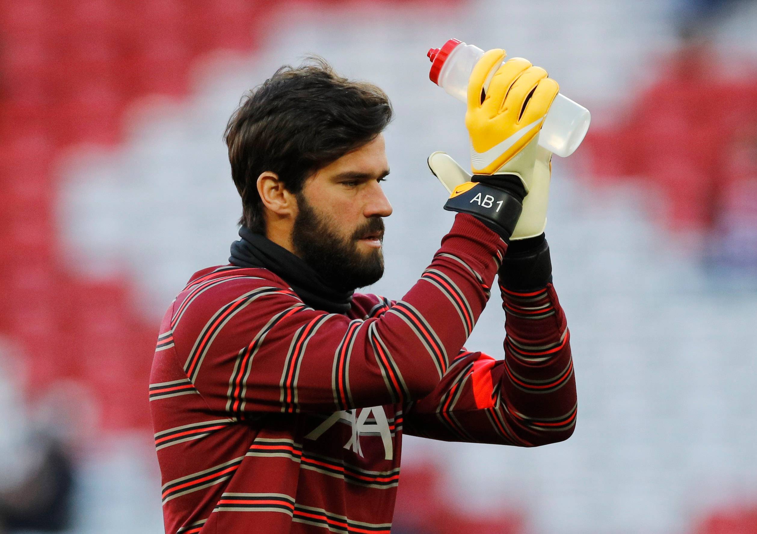 Liverpool's Alisson clapping.