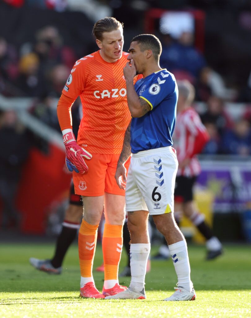 Everton's Allan chats to Pickford.