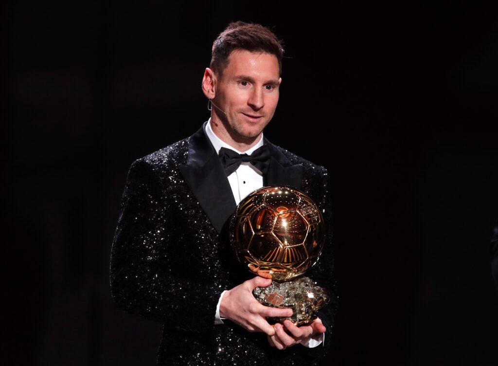 Messi holding the Ballon d'Or.