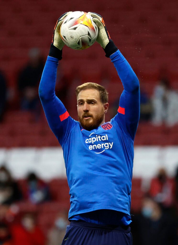 Atletico's Oblak catches the ball.