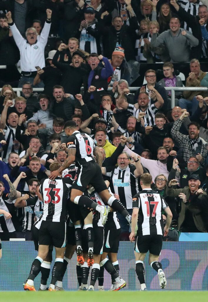 Newcastle players and fans celebrate.