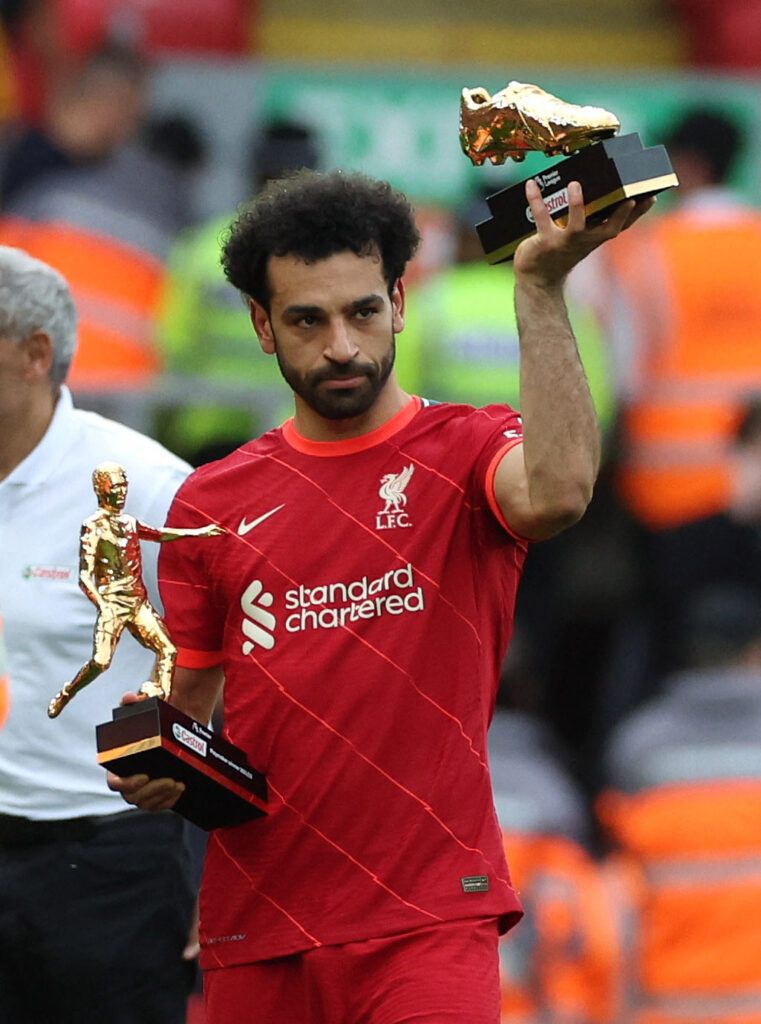 Liverpool's Salah lifting trophies.