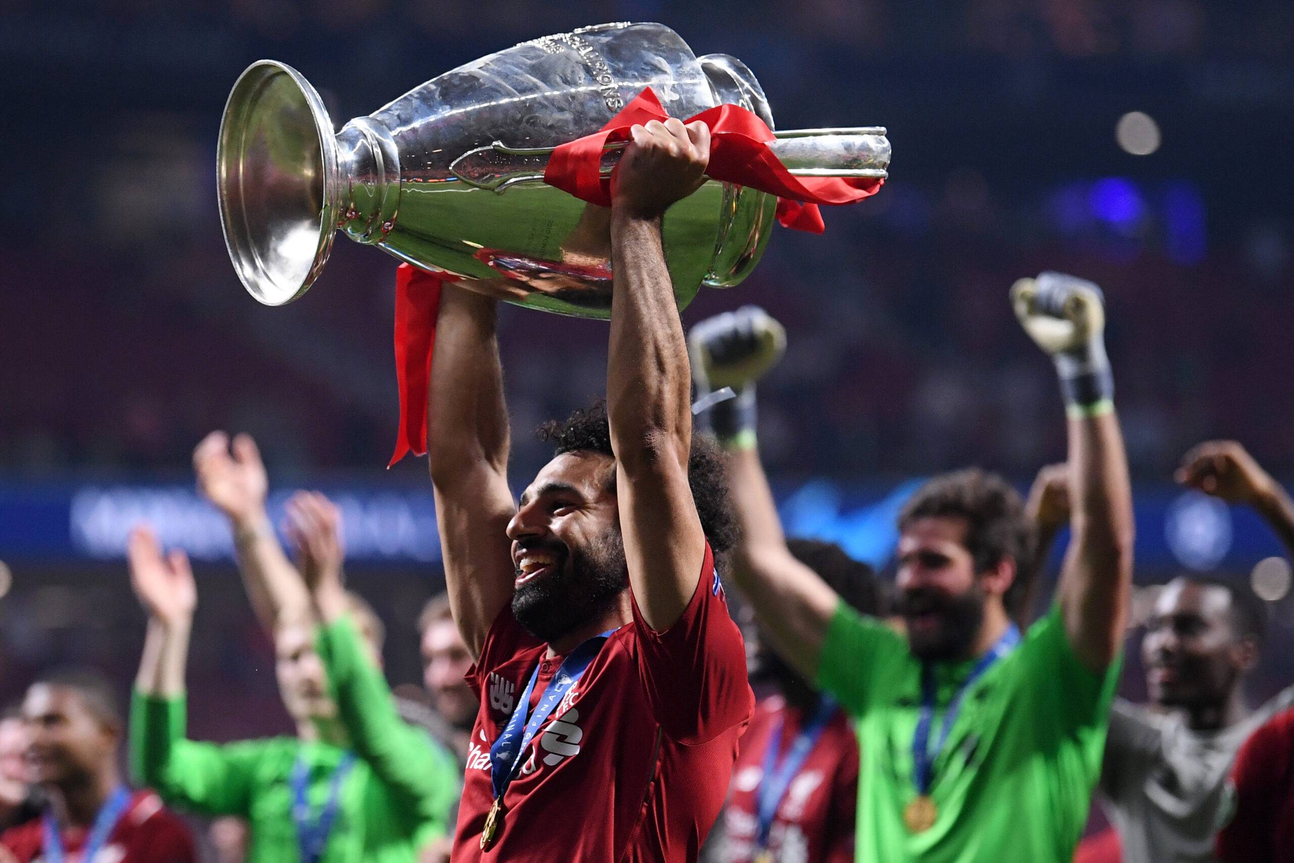 Salah lifts the Champions League trophy.