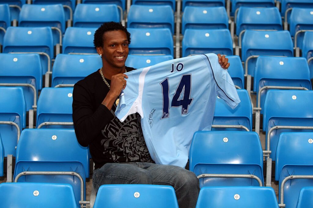 Jo poses with the Manchester City shirt upon signing in 2008
