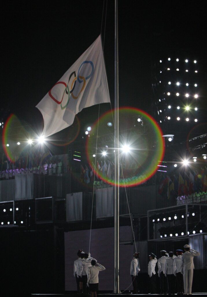 The Olympic flag is raised.