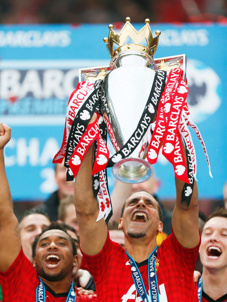 Ferdinand lifts the Premier League trophy.