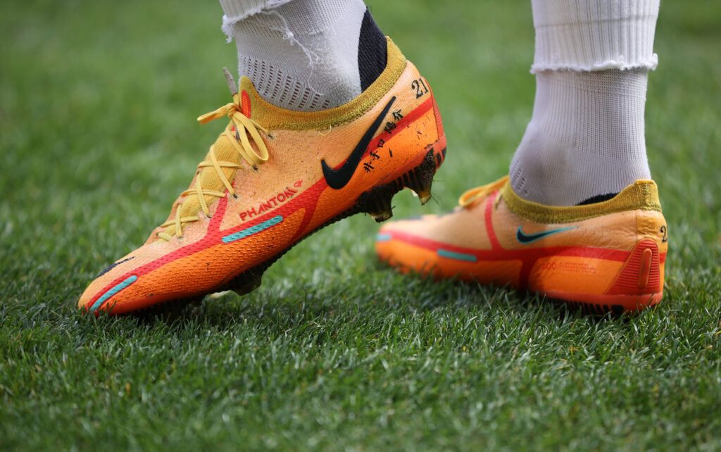 Football boots on a pitch.