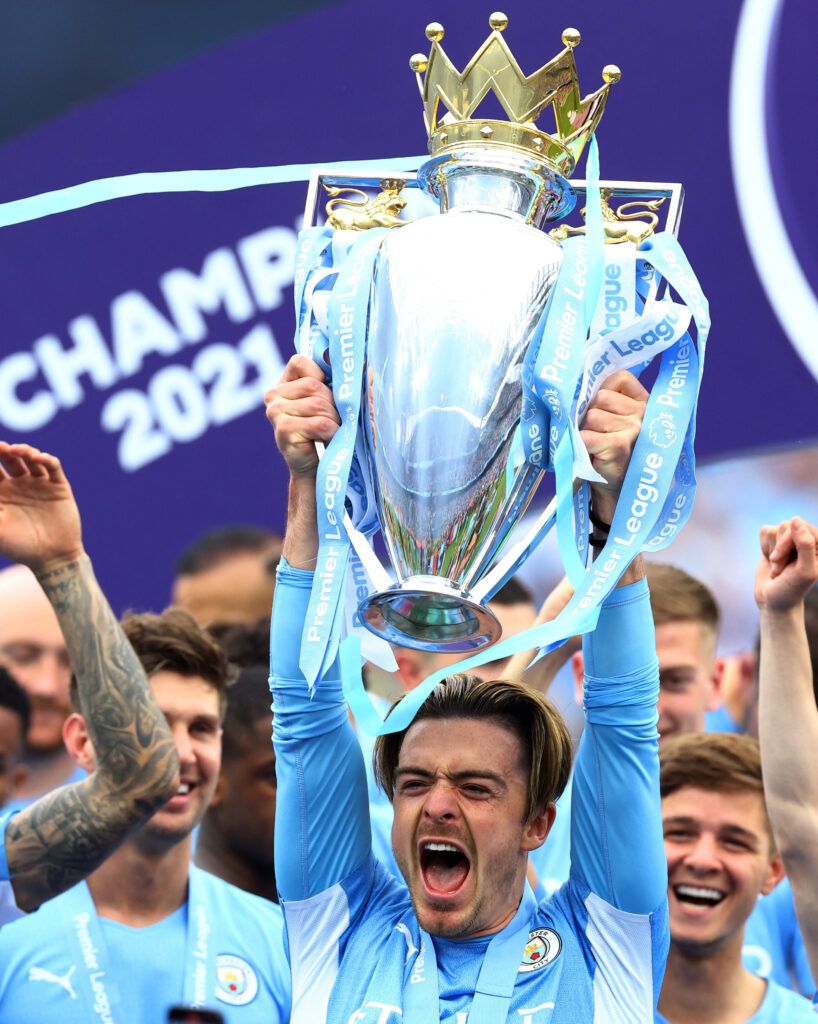 Grealish lifts the Premier League trophy.
