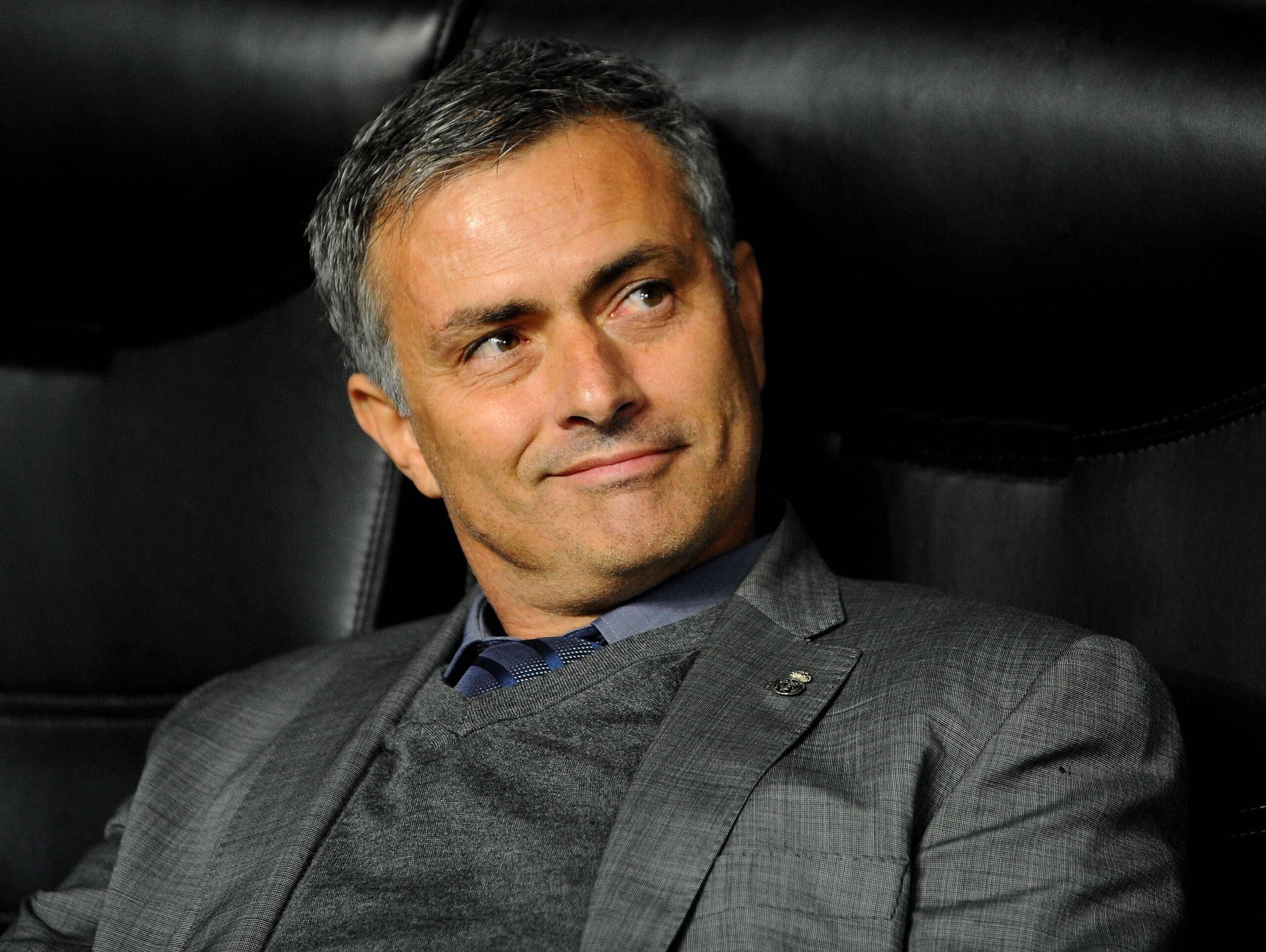 Mourinho smiles in the dugout