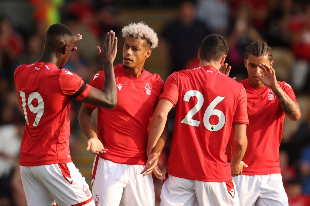 Lyle Taylor celebrates with Moussa Niakhate, Scott McKenna and Brennan Johnson of Nottingham Forest during the Pre-Season Friendly match between Nottingham Forest and Hertha Berlin at Pirelli Stadium on July 20, 2022 in Burton-upon-Trent, England