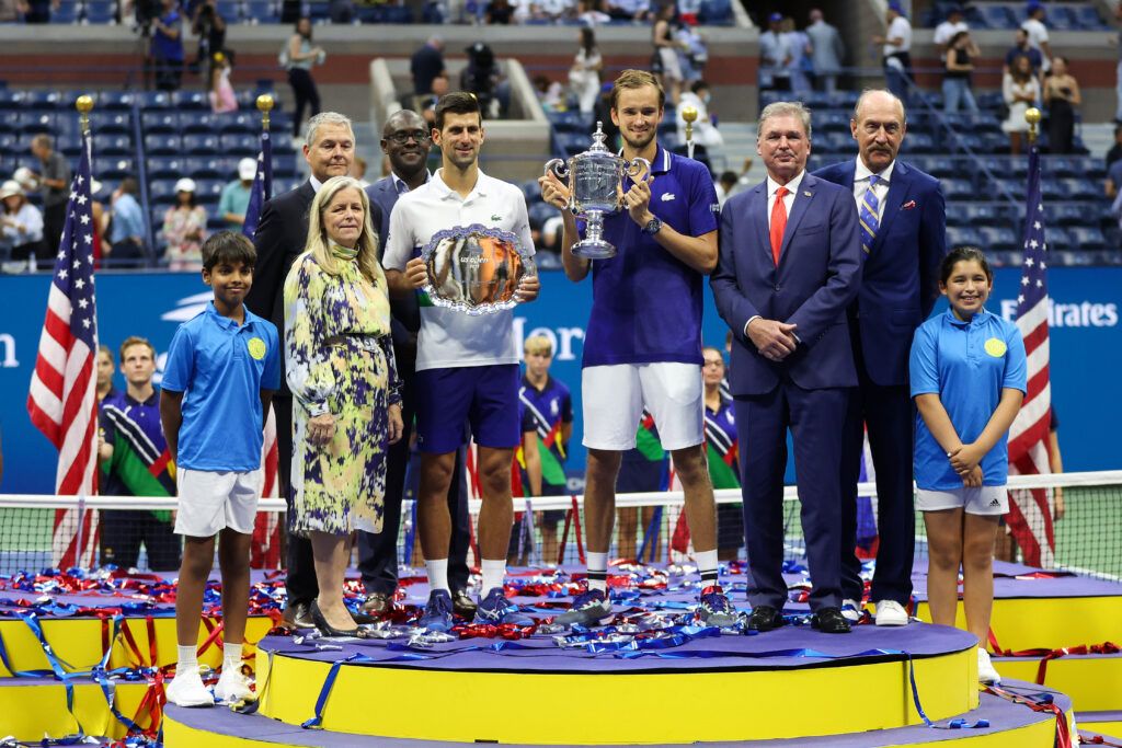 Novak Djokovic of Serbia holds the runner-up trophy alongside Daniil Medvedev of Russia who celebrates with the championship trophy after winning their Men's Singles final match on Day Fourteen of the 2021 US Open at the USTA Billie Jean King National Tennis Center on September 12, 2021 in the Flushing neighborhood of the Queens borough of New York City.  