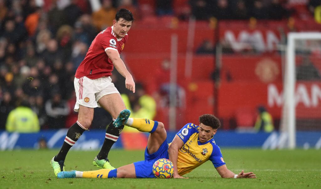 Che Adams of Southampton is challenged by Harry Maguire of Manchester United
