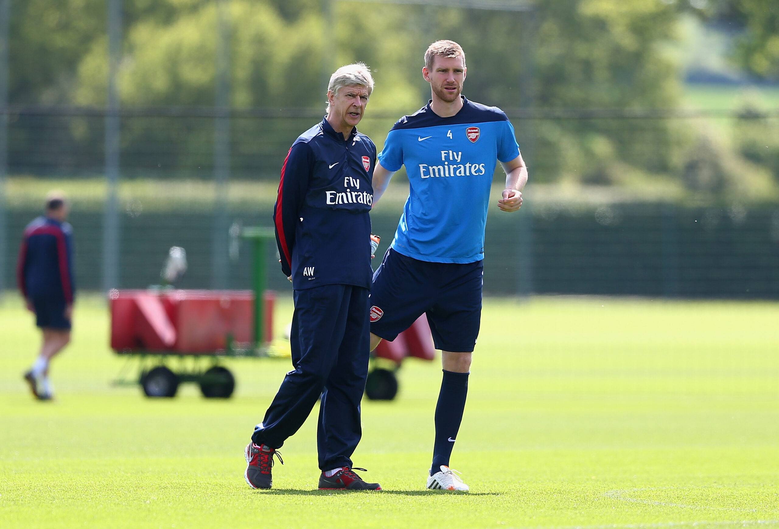 Mertesacker in training next to Arsene Wenger