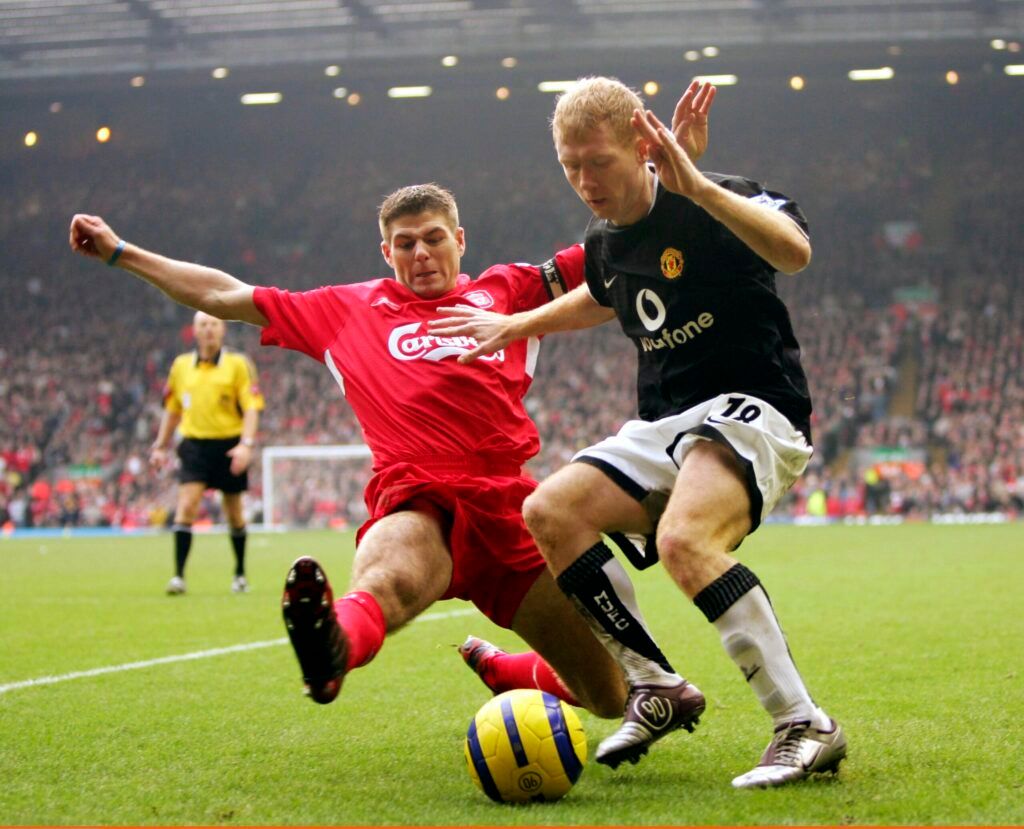 Steven Gerrard attempts to tackle Paul Scholes