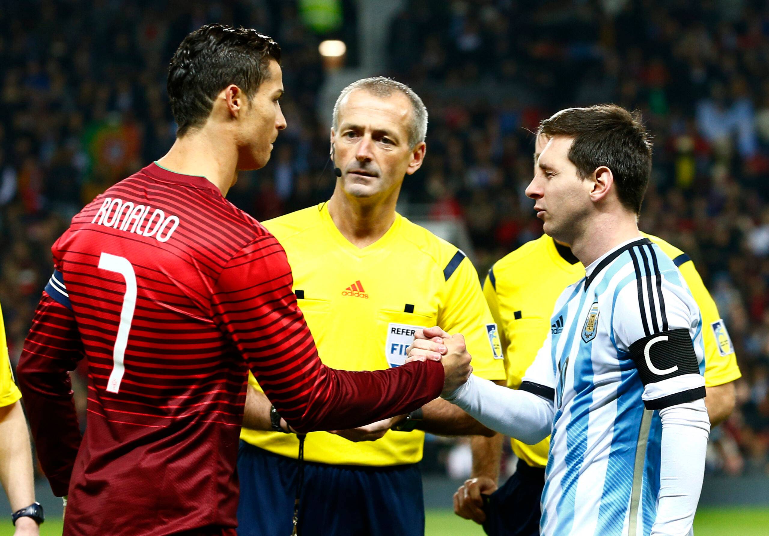 Ronaldo and Messi shake hands.