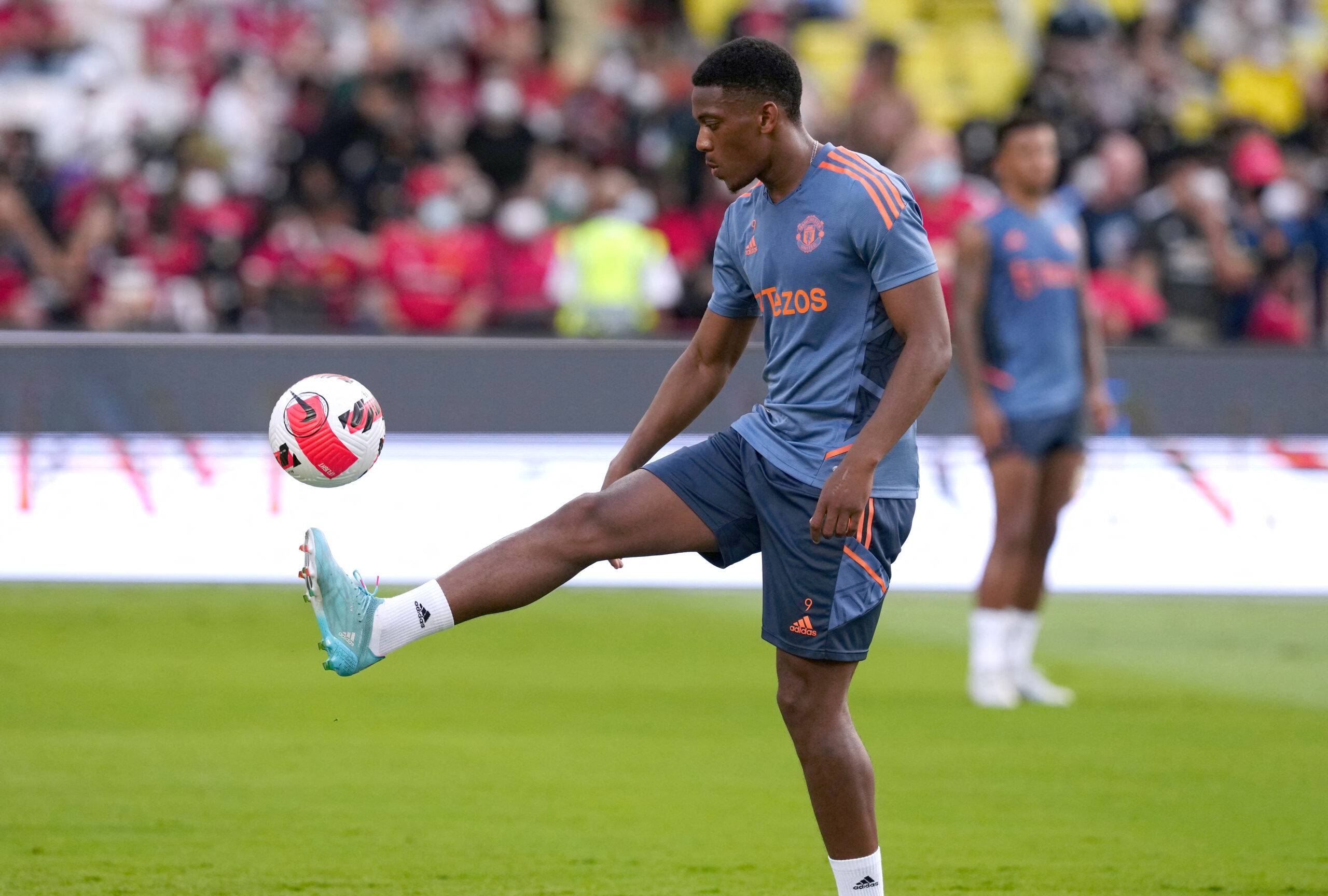 Man Utd's Martial warms up.