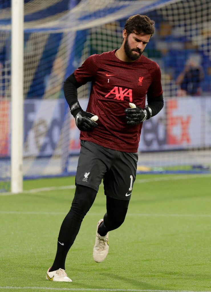 Liverpool's Alisson warms up.