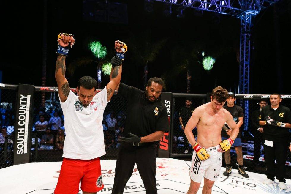 A fighter celebrates after winning at Cage Warriors 143