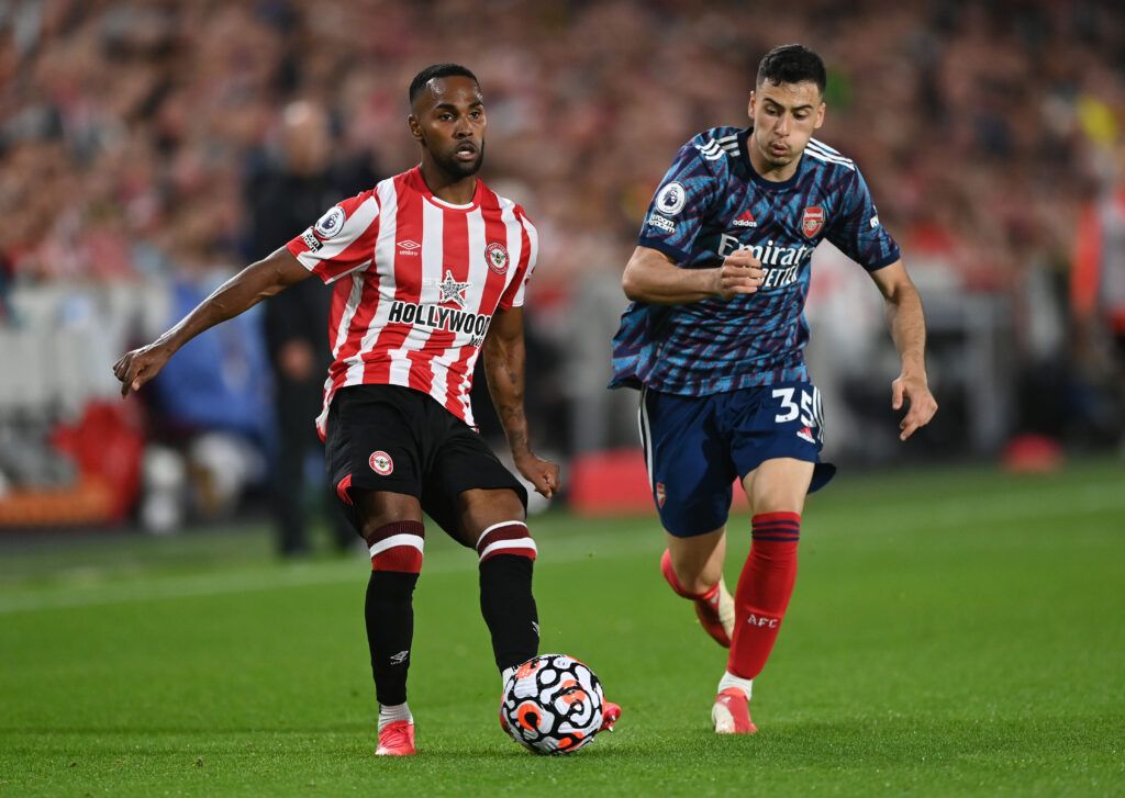  Rico Henry of Brentford controls the ball as Gabriel Martinelli of Arsenal