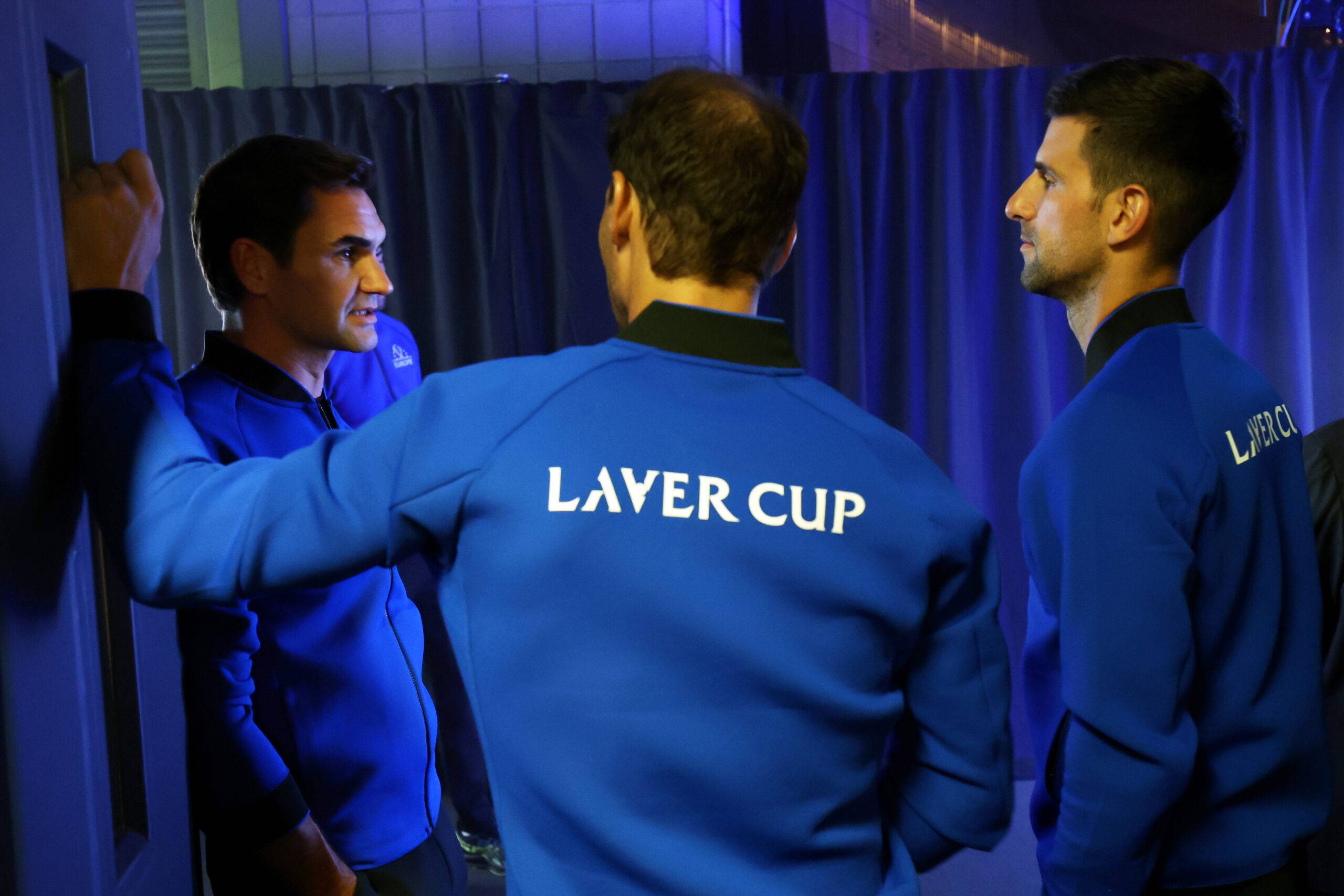Novak Djokovic chats to Roger Federer