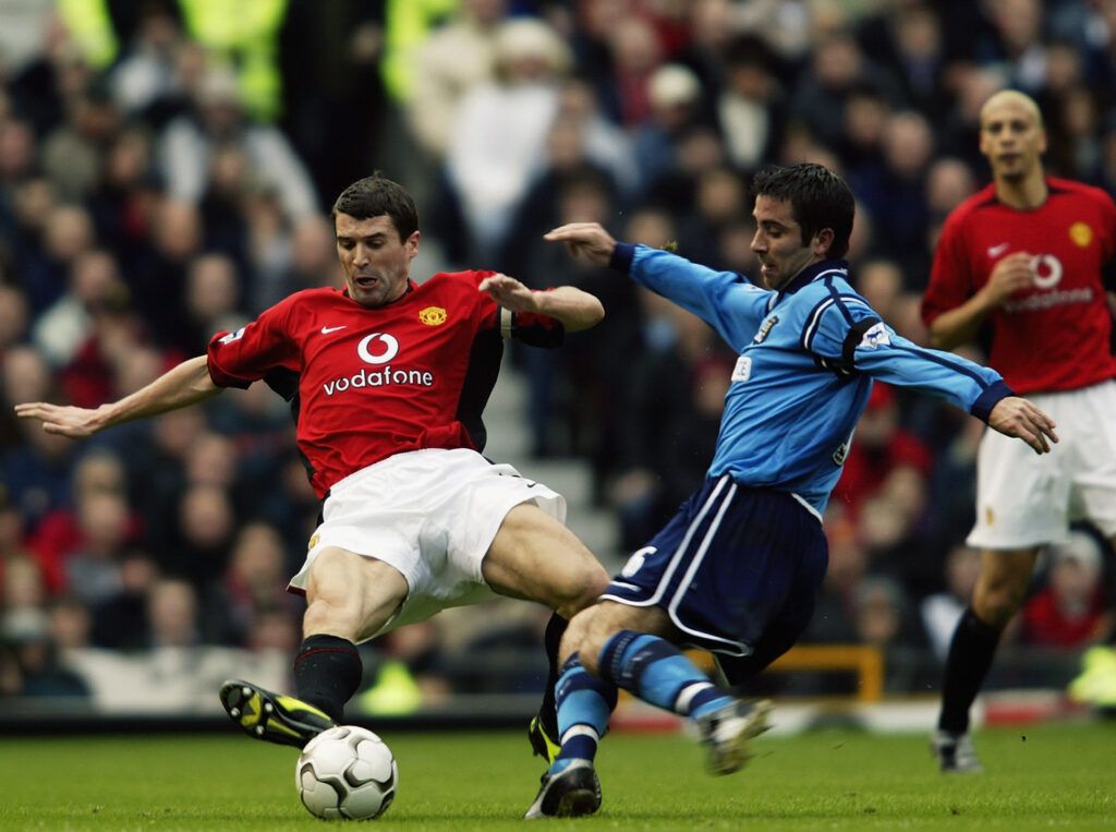 Roy Keane flies in for a tackle vs Man City