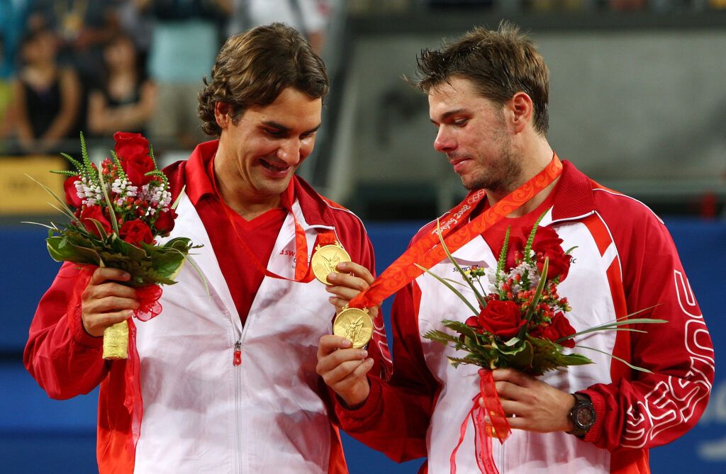Roger Federer (left) and Stanislas Wawrinka of Switzerland receive their gold medals 