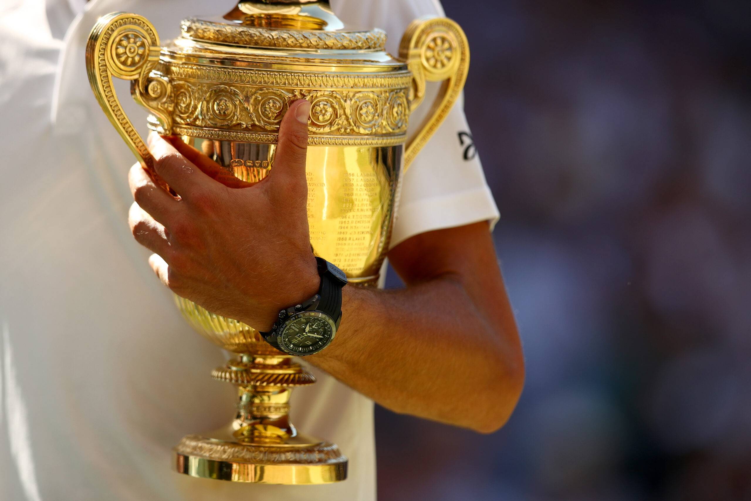The Wimbledon trophy held by Novak Djokovic.